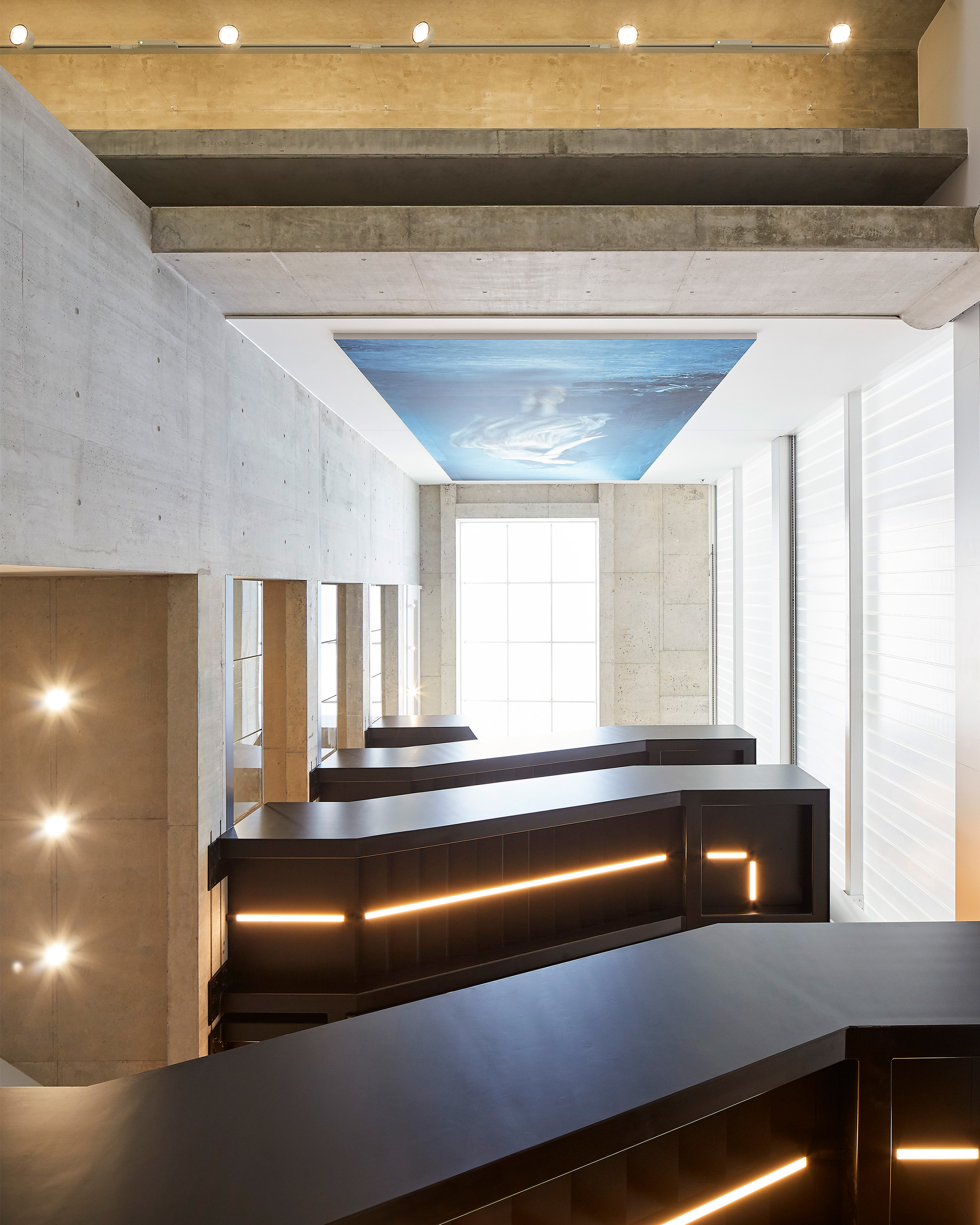 The view shows a naturally lit stairwell with hard-working materials.