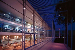 View through the glazed front elevation shows a hub of activity over three floors.