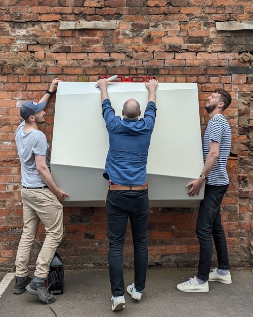 View of staff testing a facade mockup